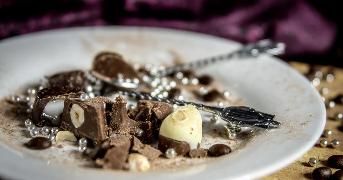 Gourmet chocolate dessert with hazel nuts on a plate. Indulgent and artistic food photography.